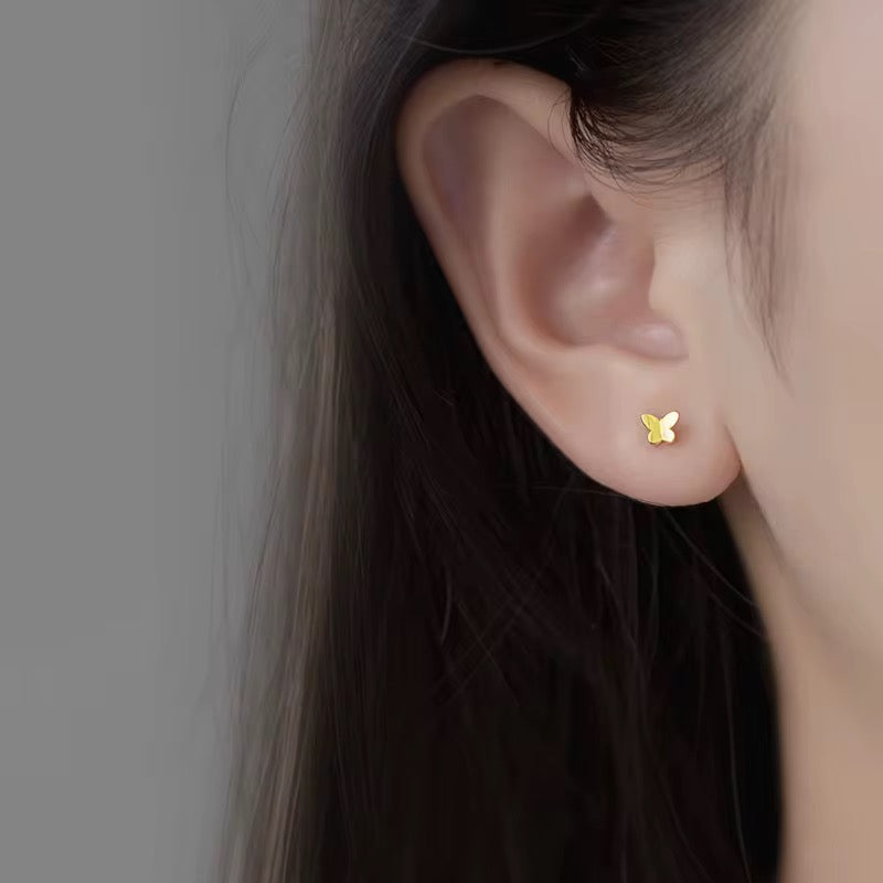 Tiny butterfly gold stud